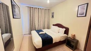 a small bedroom with a bed and a television at Frost Haven in Eldoret