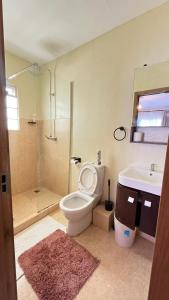 a bathroom with a toilet and a sink and a shower at Frost Haven in Eldoret