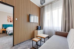 a hotel room with a couch and a bed at Hotel Andante in Prague