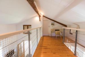 an attic hallway with a staircase and a table at Gîte du platane in Bélis