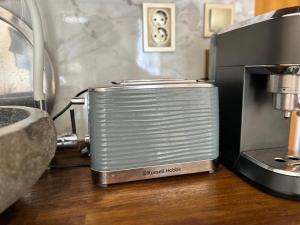 a metal toaster sitting next to a coffee maker at Bambi in Pamporovo