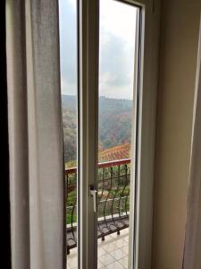 a sliding glass door with a view of a balcony at Casa Salvàn in Rodello
