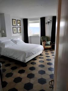 a bedroom with a bed and a chair and a window at Casa Salvàn in Rodello