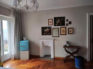 a living room with a fireplace and a chandelier at Casa Salvàn in Rodello +18 photos