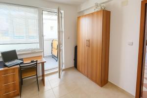 a room with a desk with a computer and a window at Family 2BDR Apartment in the City Center in Sveti Vlas