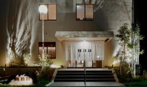 un edificio con una escalera que conduce a la puerta principal en mizuya, en Miyazu