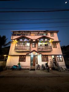 a building with two people on bikes in front of it at SeaCret by Dormer Stay in Kozhikode