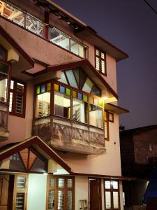 a large apartment building with a balcony at night at SeaCret by Dormer Stay in Kozhikode