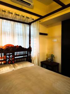 a bedroom with a large bed with a window at SeaCret by Dormer Stay in Kozhikode