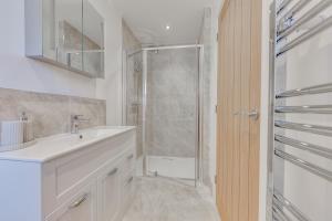 a bathroom with a sink and a shower at Luxury Cottage, Dog Friendly, Stunning Views, Private Garden in Lincolnshire +15 photos