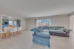 a living room with a couch and a table at Luxury Cottage, Dog Friendly, Stunning Views, Private Garden in Lincolnshire