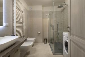 a bathroom with a toilet sink and a glass shower at Aquilegia - AffittiPontediLegno in Ponte di Legno