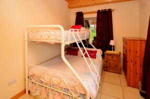 a bedroom with two bunk beds in a room at Cottage 216 - Roundstone in Roundstone