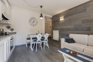 a kitchen and living room with a table and a couch at Aquilegia - AffittiPontediLegno in Ponte di Legno