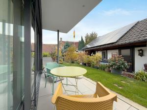 a patio with a table and chairs on a balcony at Kapps Haus in Langenargen