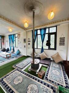 a living room with a tree in the middle at Rare House in Kalgha