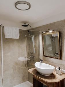 a bathroom with a sink and a shower at Traunsee Design Apartment for 2 People in Gmunden