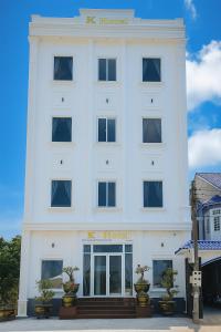 a white building with a k hospital sign on it at K Hotel Phú Quý in Cu Lao Thu