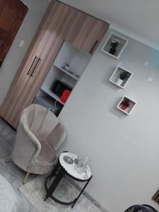 a living room with a chair and a table at Viva Guest House in Trevallyn