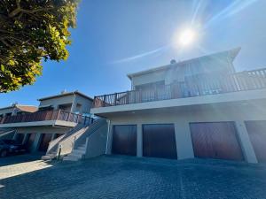 a house with the sun shining on the top of it at Brenton-On-C-View in Brenton-on-Sea