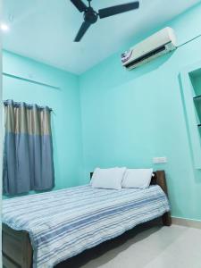 a room with a bed with a projector on the ceiling at Miracle Stay in Madurai