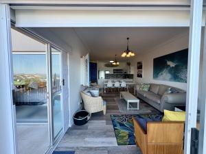 a living room with a couch and a table at Brenton-On-C-View in Brenton-on-Sea