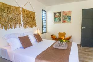 a bedroom with a large white bed in a room at Domaine Simini - Villas et Chalet entre mer et montagne in Sainte-Rose +162 photos