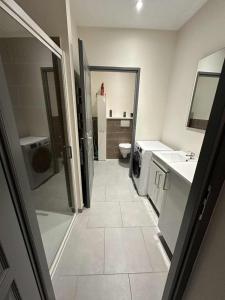 a bathroom with a sink and a toilet and a sink at Studette Peronne Centre in Péronne