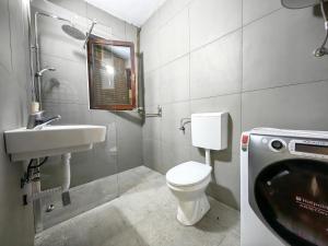 a bathroom with a toilet and a sink at Biocinovici vikendica in Kolašin +6 photos