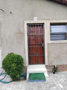 a door of a house with a green mat in front at Viva Guest House in Trevallyn +31 photos