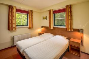 Ένα ή περισσότερα κρεβάτια σε δωμάτιο στο Vennenhof Bungalow | 8 Personen +18 φωτογραφίες