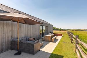 East IlsleyにあるGallopsのパティオ(パラソル、ソファ、テーブル付)