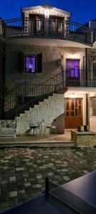 a building with a staircase and a table on a patio at Villa Marella in Trogir