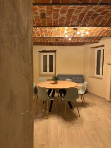a dining room with a table and chairs at FilAuri La Morra in La Morra +7 photos