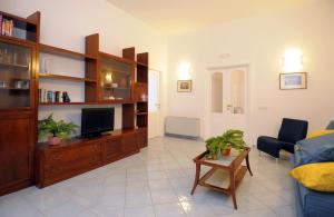 アトラーニにあるMasaniello Atraniのテレビ、ソファ、テーブルのあるリビングルーム