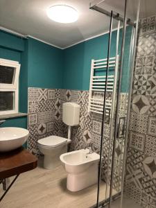 a bathroom with a toilet and a sink at FilAuri La Morra in La Morra