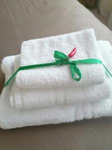 a stack of towels with a flower on top at Casa Giardina in Catania +55 photos