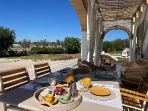 a table with food on it on a patio at Villa Chiara by salentoltremare in Corsano