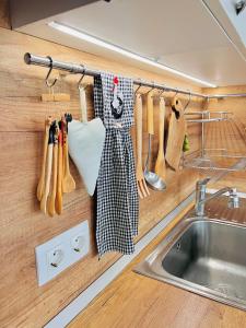 a kitchen with a sink and utensils on a rack at Cosy Dream Appartment near Borovets in Samokov