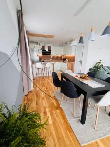 a dining room and kitchen with a table and chairs at Cosy Dream Appartment near Borovets in Samokov