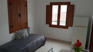 a small bedroom with a bed and a window at Casa Do Sino II in Arcos de Valdevez