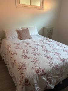 a bed with a white comforter with a pillow on it at Casa Do Sino II in Arcos de Valdevez