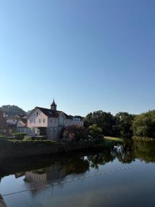 a house on the side of a river at Casa Do Sino II in Arcos de Valdevez