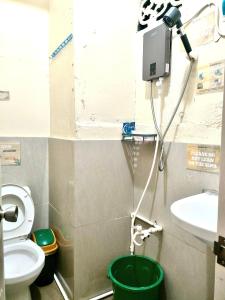 a bathroom with a toilet and a sink at Capsutel in Baguio