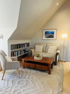 a living room with a couch and a coffee table at Blue Pearl - Old Bar Holiday Rentals in Old Bar +16 photos