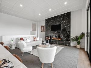 a living room with a couch and a fireplace at Refined Luxury – Modern 3-Bedroom House by Marina in Frankton Wharf