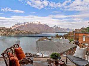 a balcony with a view of a lake and mountains at Refined Luxury – Modern 3-Bedroom House by Marina in Frankton Wharf
