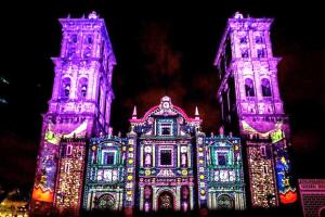 a building covered in lights with two towers at Amazing View From Los Fuertes in Puebla +2 photos