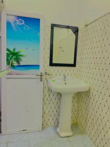 a bathroom with a white sink and a mirror at The Hiddenway Weligama in Weligama