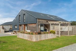 a house with a black roof and a fence at Butterfly in Boston